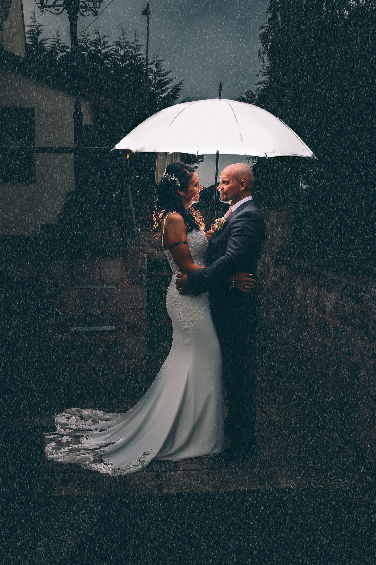 Bride and Groom sheltering from the rain