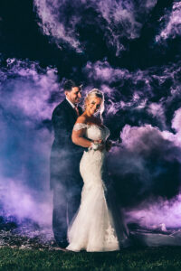 Bride and Groom with smoke Bombs at Beeston Manor
